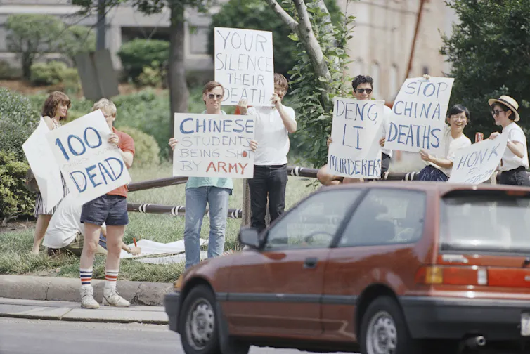 Demonstrators protest outdoors.