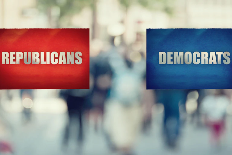 Hands holding cards saying Republicans and Democrats.