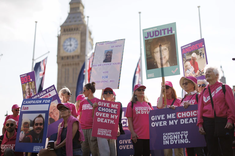 A group of pro-assisted dying protestors outside the Houses of Parliament
