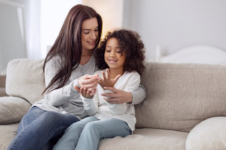 Mother and child count fingers together