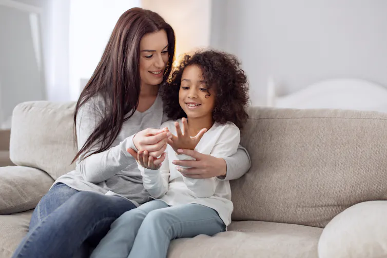 Mother and child count fingers together