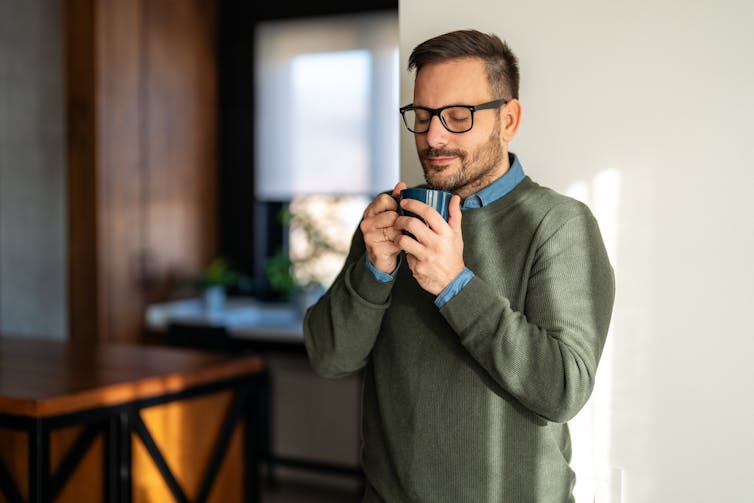 Man meditates while drinking morning coffee