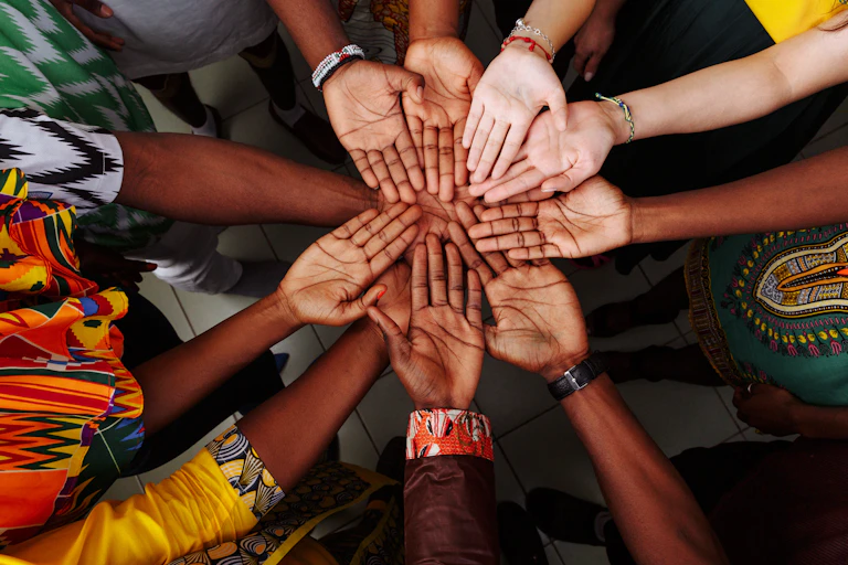 10 arms in a circle joining in the centre with 10 hands, palms faced up, forming a kind of flower.