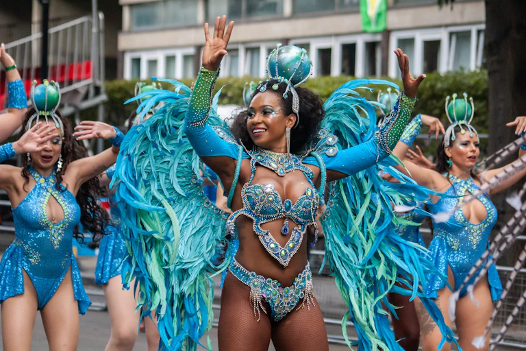 Dancers at the Notting Hill Carnival wearing blue feathered wings