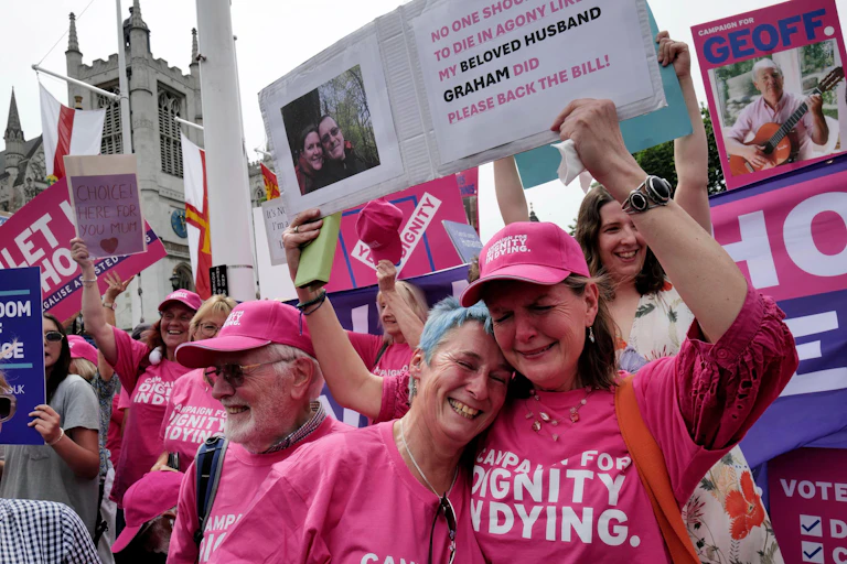Two pro-assisted dying campaigners crying with joy.