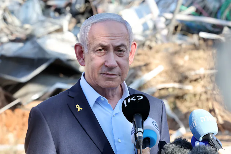 Israel's prime minister, Benjamin Netanyahu, visiting the site of an Iranian missile attack.