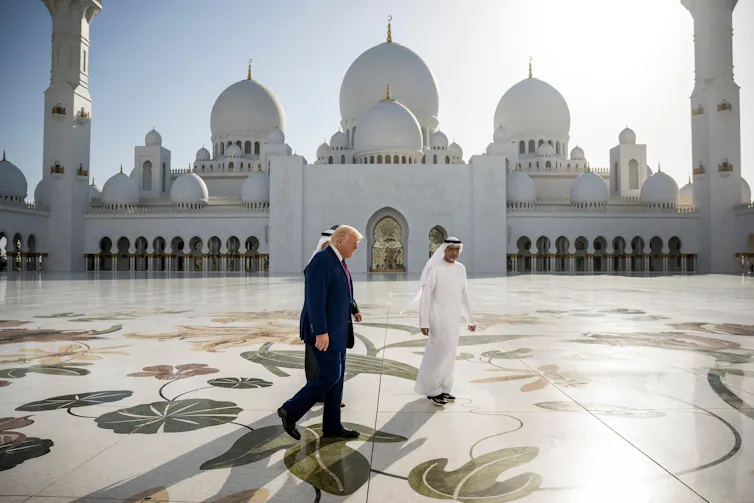 Donald Trump with Crown Prince Sheikh Khaled bin Mohamed walk past the Sheikh Zayed Grand Mosque in Abu Dhabi in May 2025.