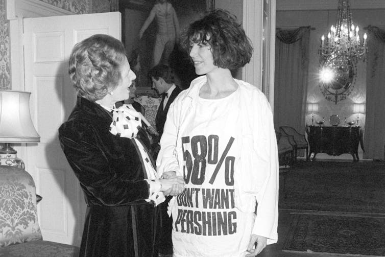 A temporary historical past of the slogan T-shirt 1 Katharine Hamnett meets Margaret Thatcher while wearing a shirt protesting nuclear weapons.