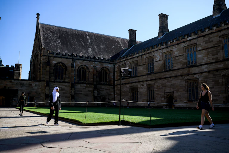 Students walk in the main quadrangle of Sydney University.