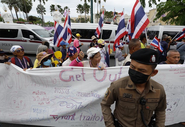 A border struggle would possibly value the Thai top minister her process 1 A Thai police officer stands guard during a rally calling for the resignation of Paetongtarn Shinawatra.