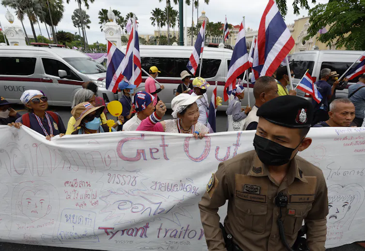 A Thai police officer stands guard during a rally calling for the resignation of Paetongtarn Shinawatra.
