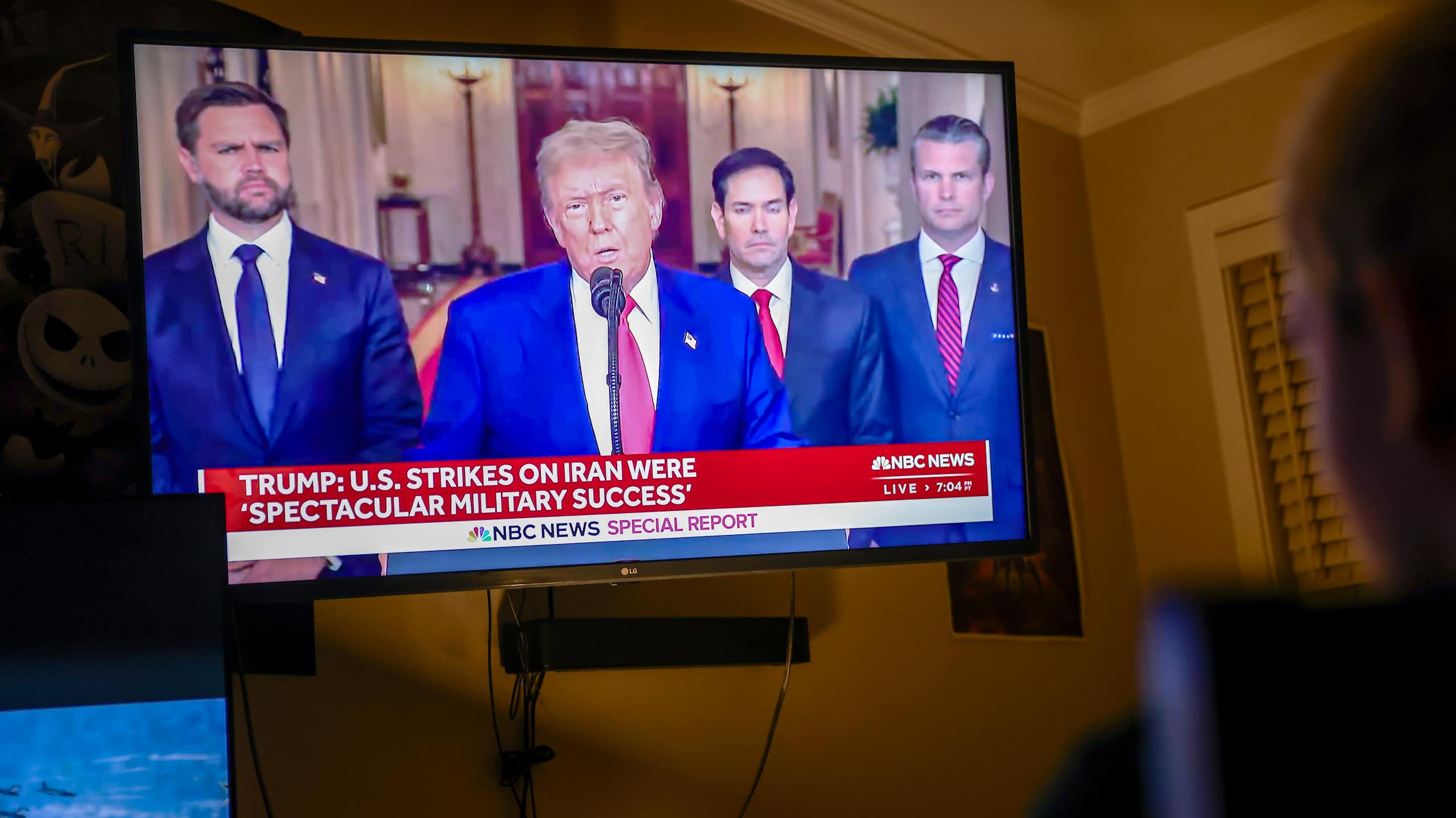 A television showing US president Donald Trump, flanked by vice-president J.D. Vance, secretary of state Marco Rubio and defense secretary Pete Hegseth and M