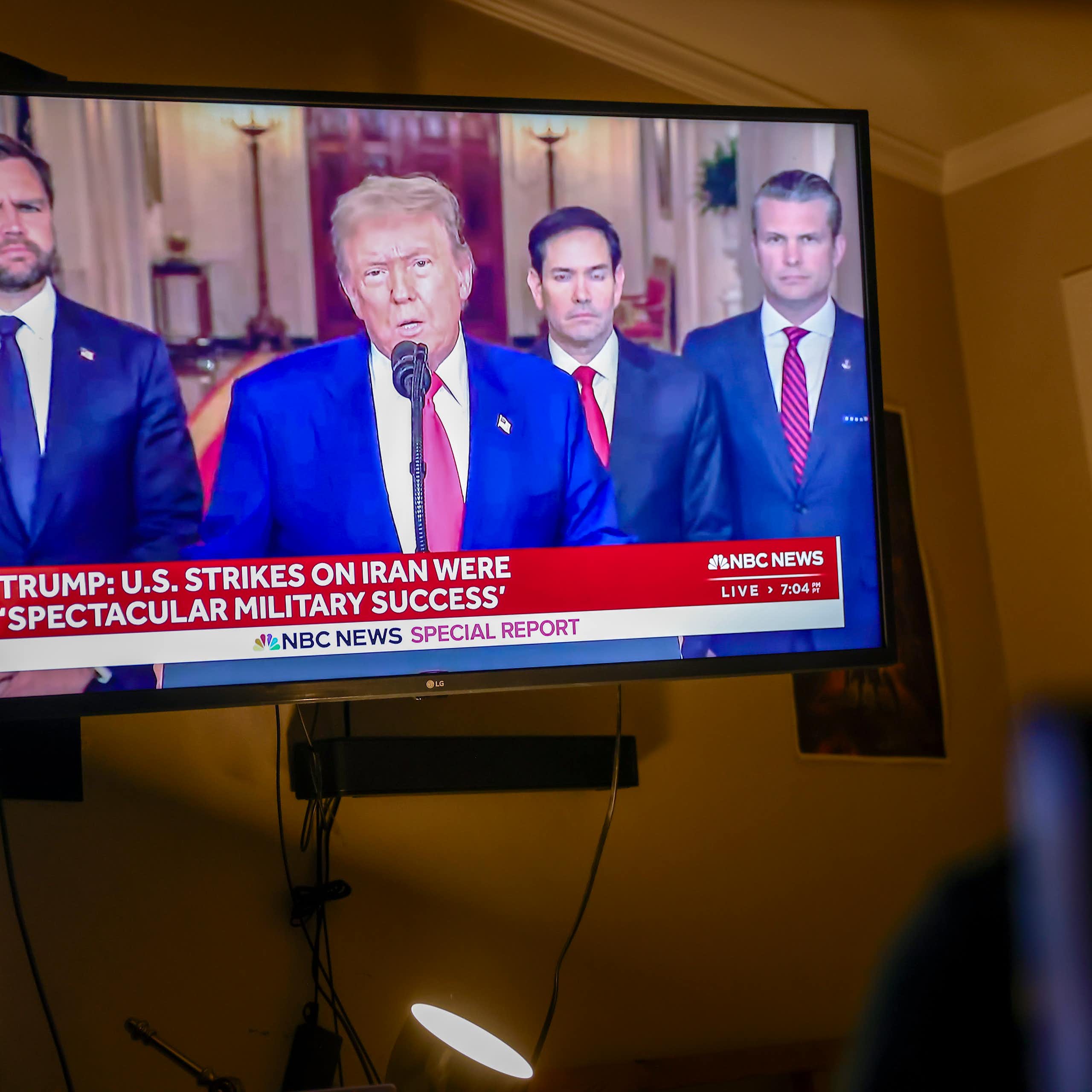 A television showing US president Donald Trump, flanked by vice-president J.D. Vance, secretary of state Marco Rubio and defense secretary Pete Hegseth and M