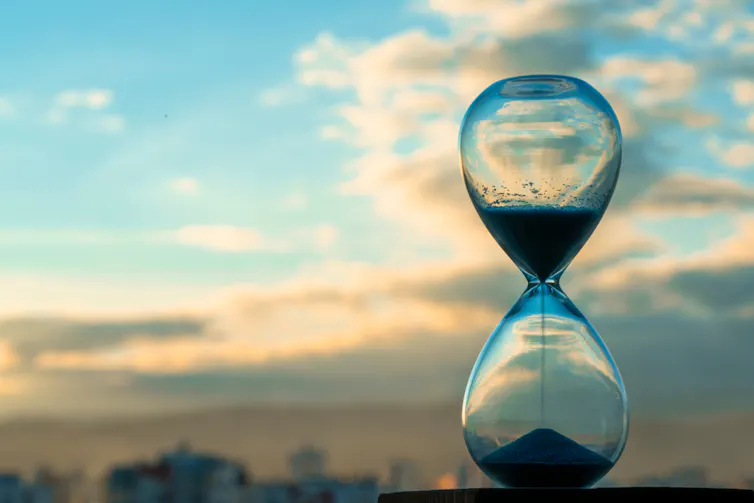 hourglass, sand timer, blue sky in background