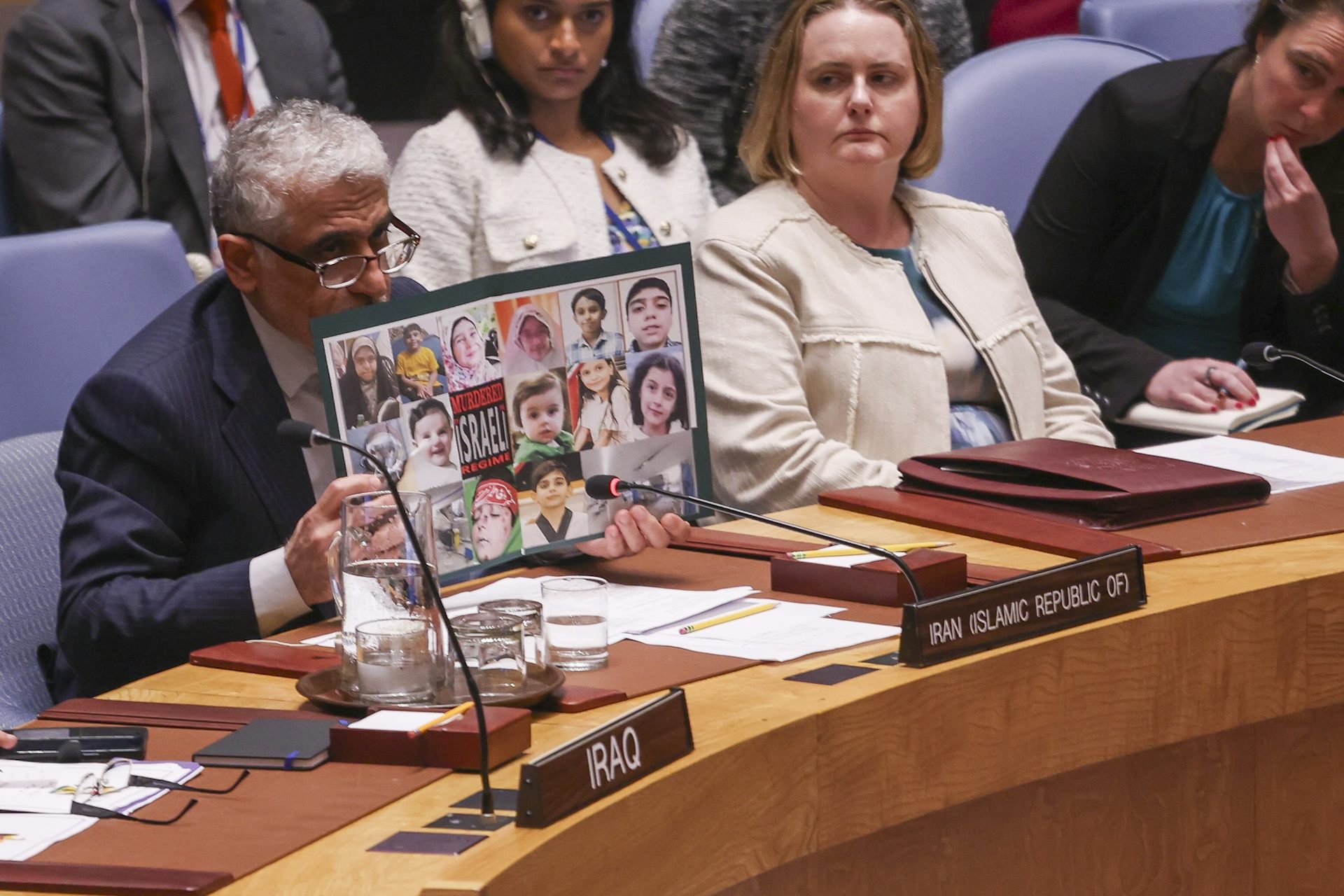 Iran's ambassador to the UN, Amir Saeid Iravani holds up a poster with photographs of children killed in israeli airstrikes in Iran June 202 2025.