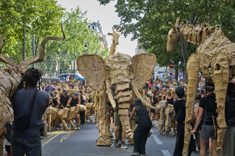 giant elephant puppet walking through crowds in Paris