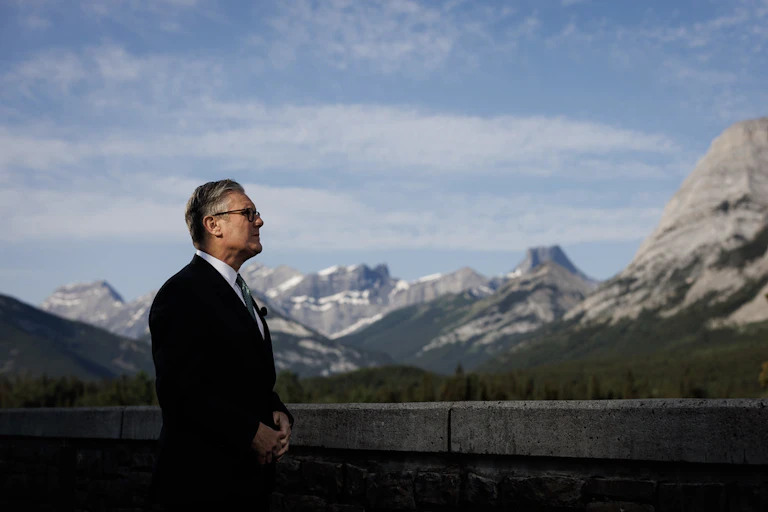 Keir Starmer pictured in front of a mountain scene in Canada.