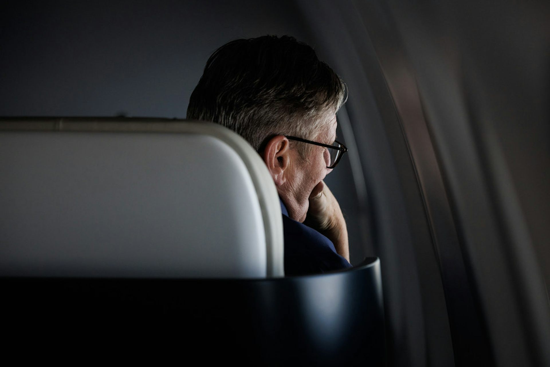 Keir Starmer looking out of an aeroplane window.