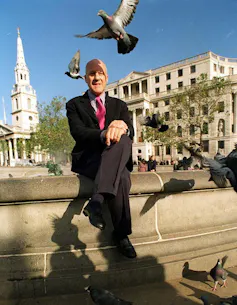 Norman Foster surrounded by pigeons