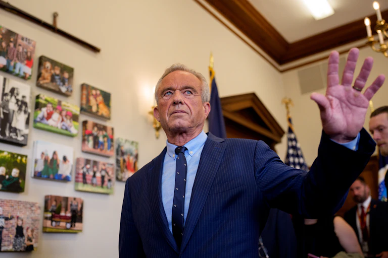 Health Secretary Robert F. Kennedy, Jr. holds up his hand at a Make America Healthy Again event.
