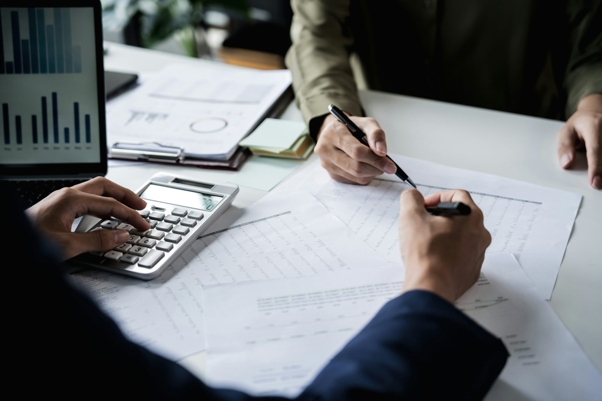 Des personnes sont assises à une table avec des crayons en main