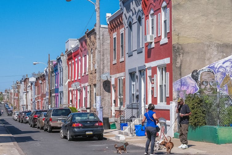 Block of colorful row homes on sunny day