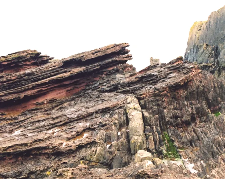 A rock formation with two layers of rocks in contrasting directions.