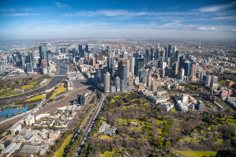 Arial view of Melbourne CBD, inclusing skyscrapers and parkland.