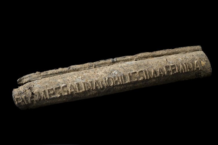 old lead water pipe on black background.