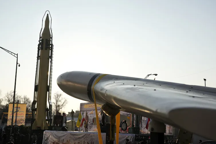 A military parade featuring a missile and a large drone.