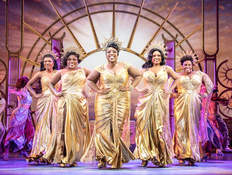 The muses wearing gold dresses