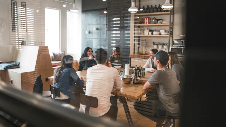 Group of people having a meeting around a conference table in an office