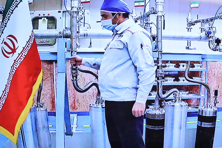 A handout picture made available by the Iranian presidential office in 2021 shows a technician working inside the Iran's Natanz uranium enrichment plant.