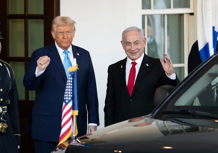 Donald Trump fist pumping next to Benjamin Netanyahu outside the White House.