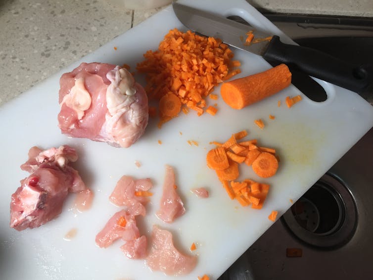 The same cutting board used to chop up chicken and dice carrots.