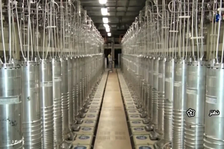 two parallel rows of vertical metal tubes with hoses attached to the tops