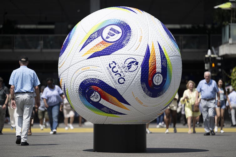 Euro 2025: ladies’s soccer has exploded – right here’s the way it can develop much more 1 People walk by a giant football.