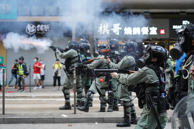 Police in riot gear firing on Hong Kong protestors