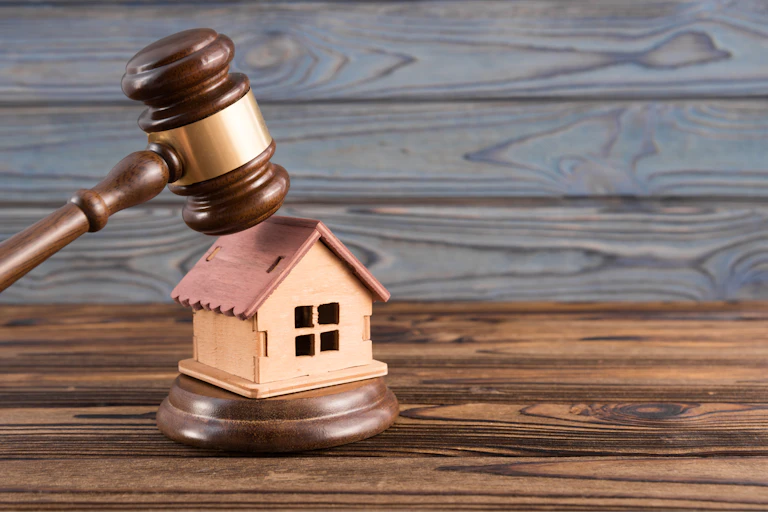 wooden house, judge's gavel on wooden background. purchase, sale of real estate, housing
