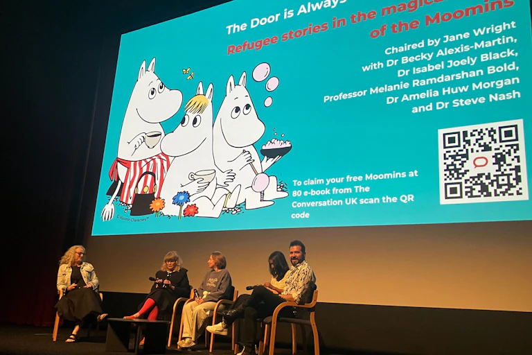 Panelists on stage for a Moomin event