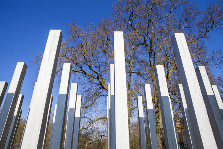 The 7/7 memorial in Hyde Park, a collection of vertical steel columns, against a blue sky