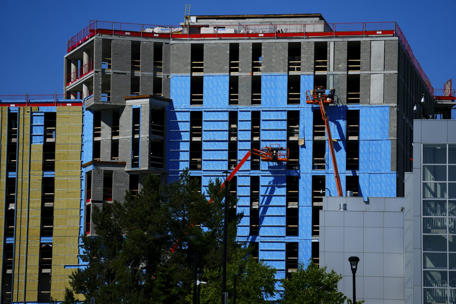 A worker on a scaffolding as a building is under construction.