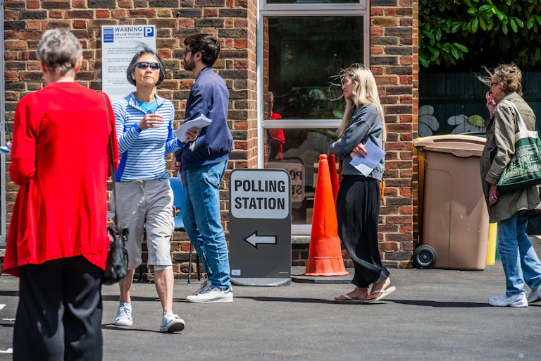 People waiting outside a polling station to vote.