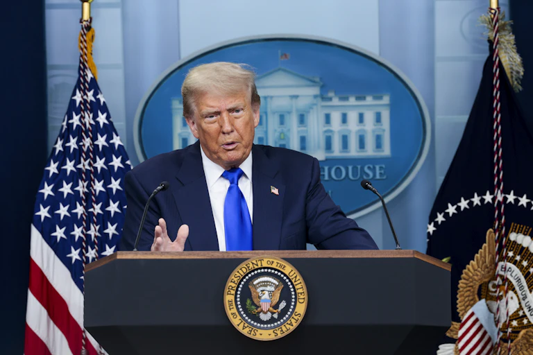 Donald Trump speaks from White House podium.