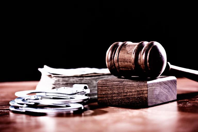 Wooden gavel and handcuffs