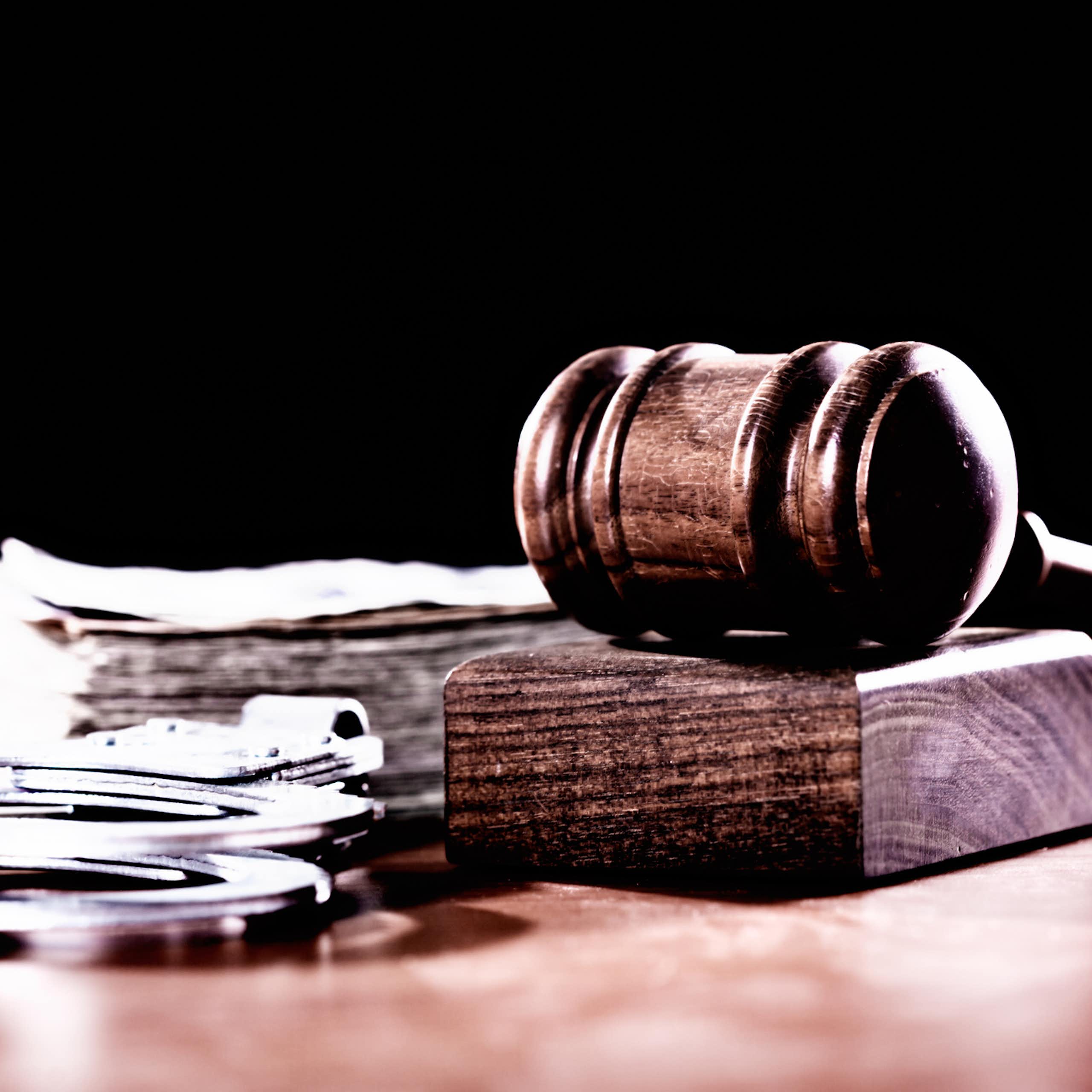 Wooden gavel and handcuffs