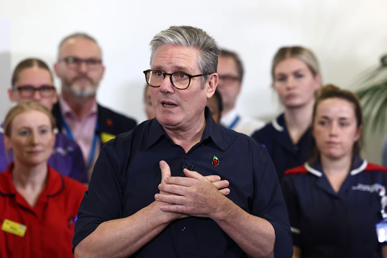 Prime Minister Keir Starmer speaks with members of staff, during a visit to University Hospital Coventry and Warwickshire, in Coventry, England.