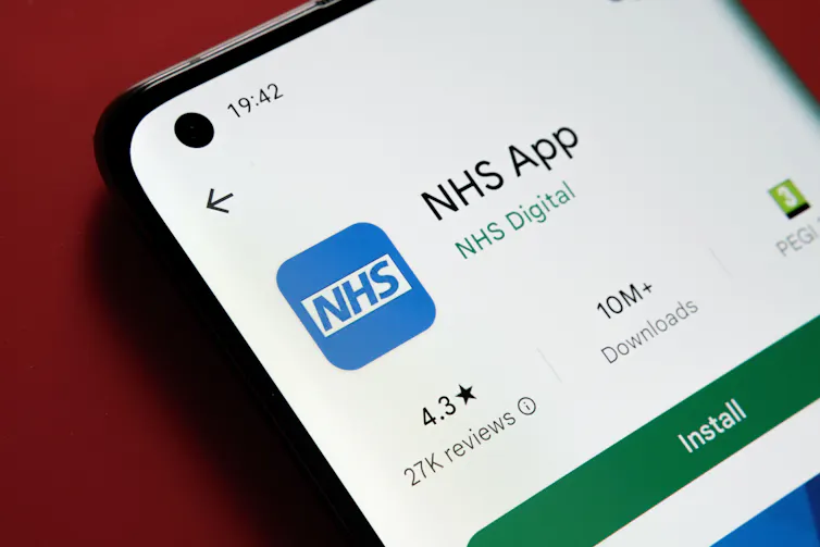 A phone showing the NHS app.