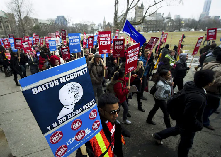 Students with placards outdoors.