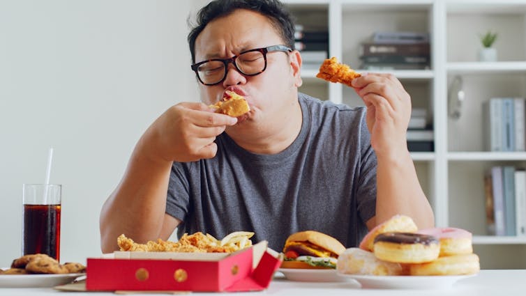 A man tucks in to fast food.